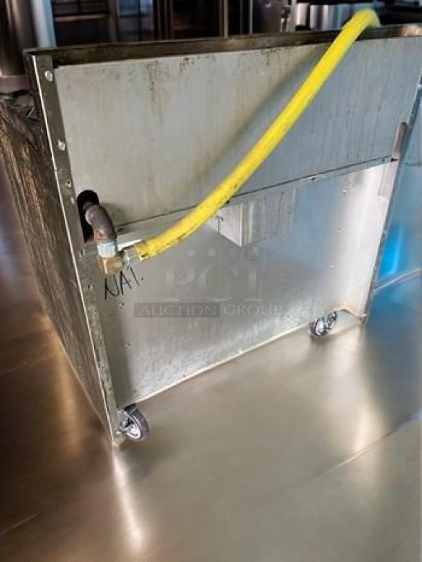 Back view of Royal Range RR-6 6-burner gas range, natural gas, with yellow gas hose, on caster wheels. Excellent condition.