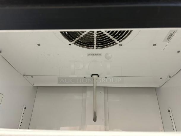 True GDM-26-HC~TSL01 merchandiser interior, shelves not visible, clean white finish, shows cooling vent. Excellent condition.