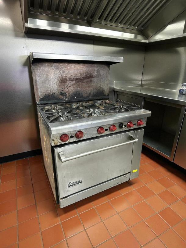 American Range AR-6, 36" six-burner gas range with standard oven. Tested and in great condition. Visible brand label.