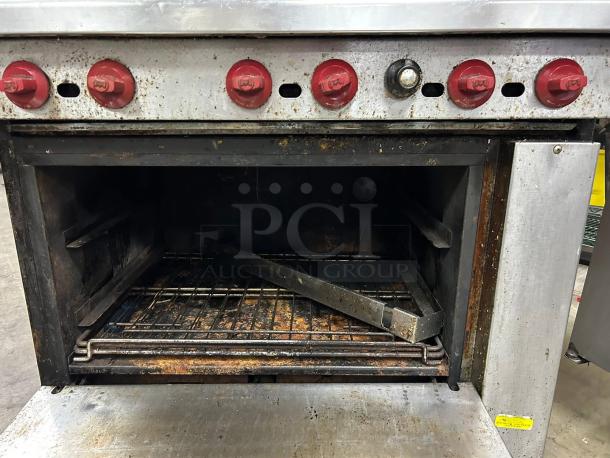 American Range AR-6, 36" six-burner gas range with standard oven. Features red control knobs; tested and working. Signs of use.