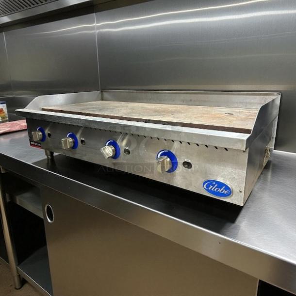 Globe GG48G 48" gas griddle with manual controls, 1" steel plate, in working condition, ideal for commercial kitchens.