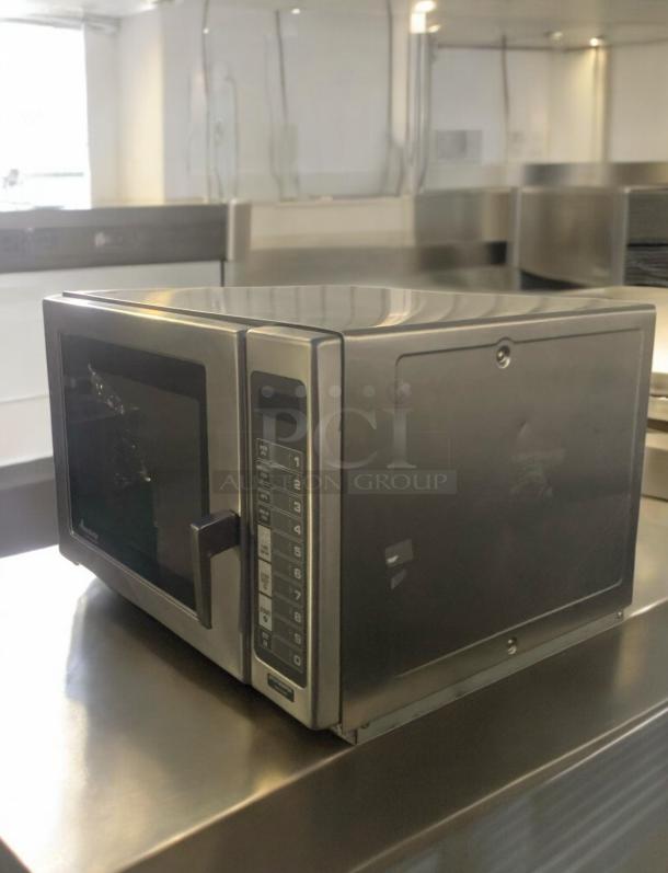 Amana RFS12MPSA commercial microwave oven, 1200W, 120V, outstanding condition, stainless steel exterior, keypad controls.