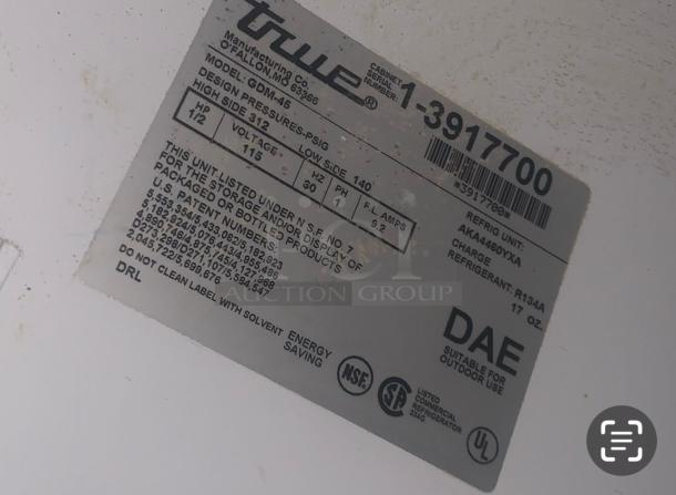Label on True GDM-45 Merchandiser Refrigerator, showing model details, 115V, 9.2 Amps, NSF certified, R134A refrigerant.