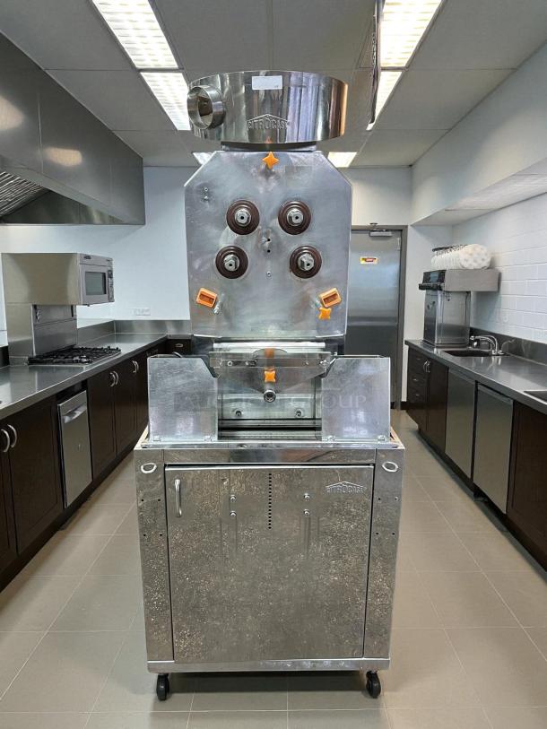 Citrocasa 8000 SB-ATS Advance Citrus Juicer with base, metallic finish, sold as is, located in a commercial kitchen.