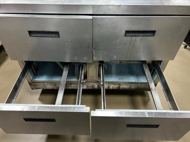 Delfield D4448NP-12 sandwich prep refrigerator with 4 drawers, stainless steel, tested and working. Some wear visible.