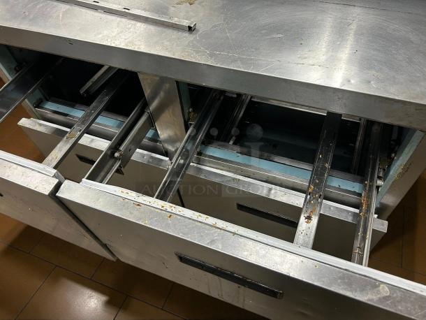 Delfield D4448NP-12 48" prep refrigerator, features 4 stainless steel drawers, minor wear, tested, and working condition.