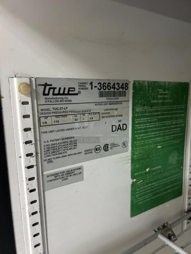 True TUC-27-HC-LP undercounter refrigerator in excellent condition. Model and specs tag visible, 115v tested.