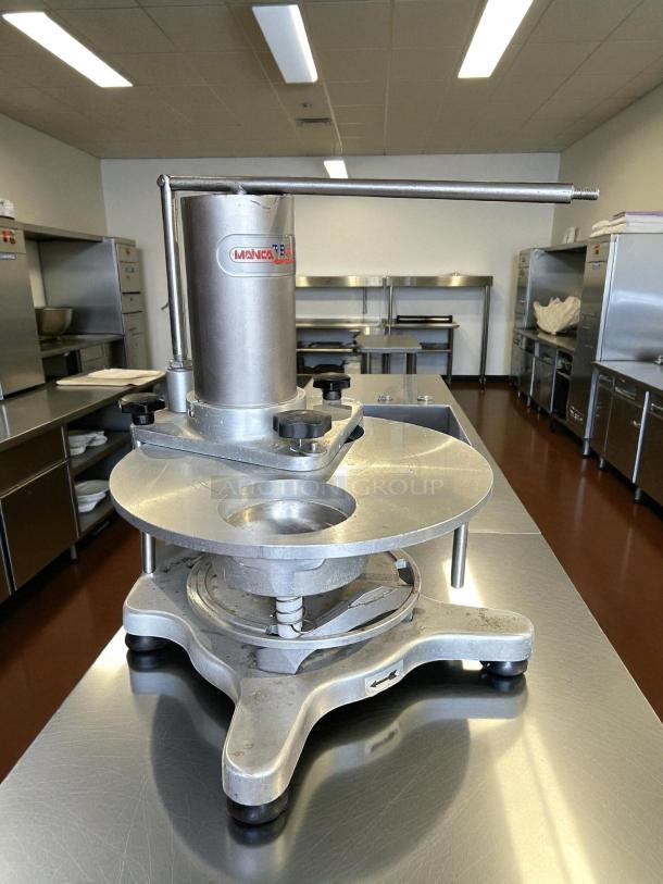 Mainca MH-120 manual hamburger patty press in great condition. Tested and working. Durable metal construction with a visible brand label.