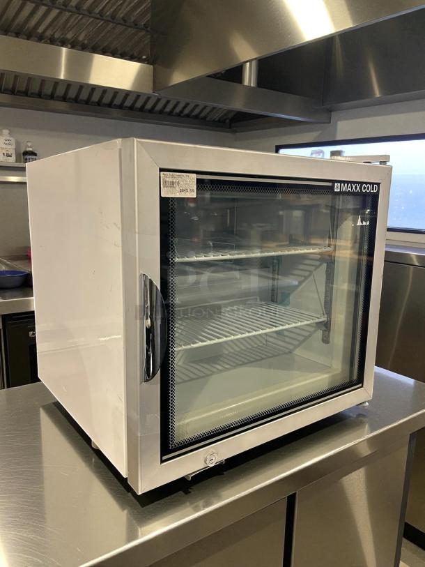 Like new Maxx Cold MXM1-2FHC countertop glass door merchandiser freezer, clean condition, visible price tag.
