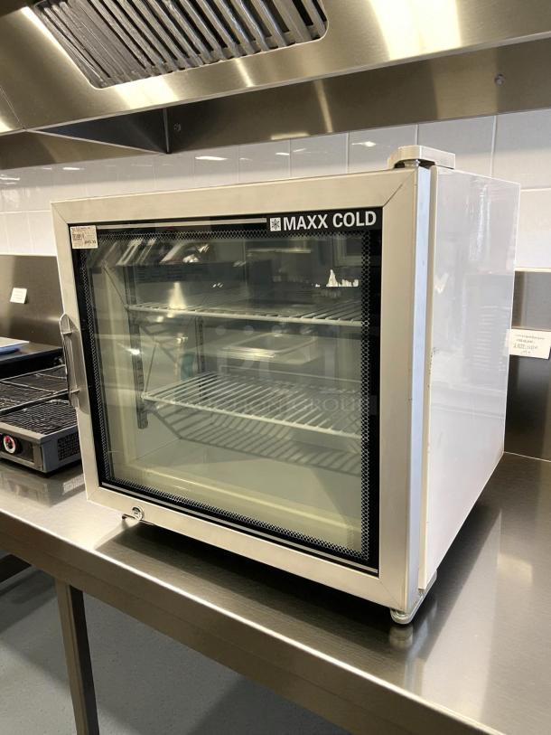 Maxx Cold MXM1-2FHC countertop glass door merchandiser freezer, like new, stainless steel finish, glass door, interior shelving.