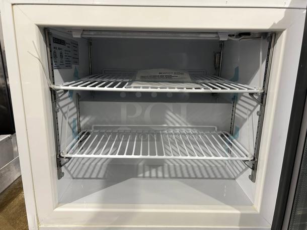 Like New Maxx Cold MXM1-2FHC countertop merchandiser freezer with glass door, dual shelves, and manufacturer label.