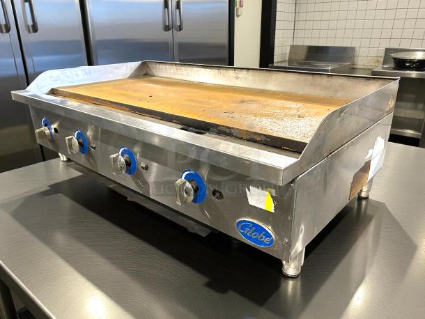 Globe GG48TG 48" gas griddle with thermostatic controls and 1" steel plate, excellent condition, tested and working.