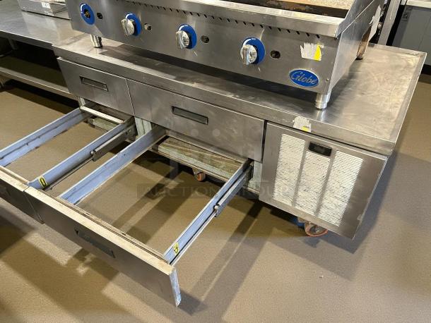 Delfield F2962CP chef base with four drawers, stainless steel, tested and working, 62 1/4" width, 115v power, on wheels.