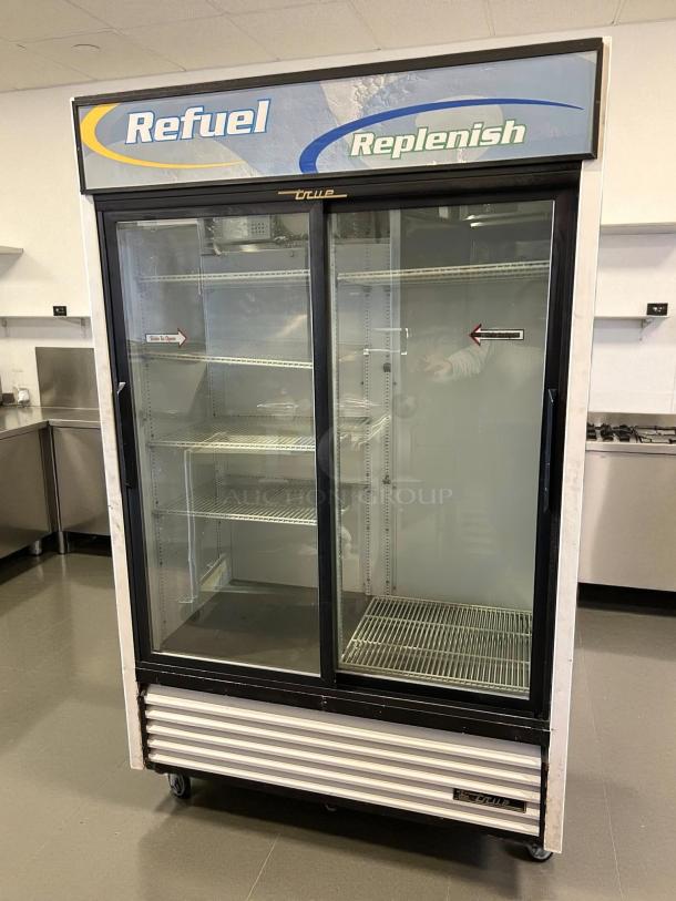True GDM-45-HC-LD merchandiser with two sliding glass doors, black finish, 51 1/8", tested working, marked "Refuel Replenish".