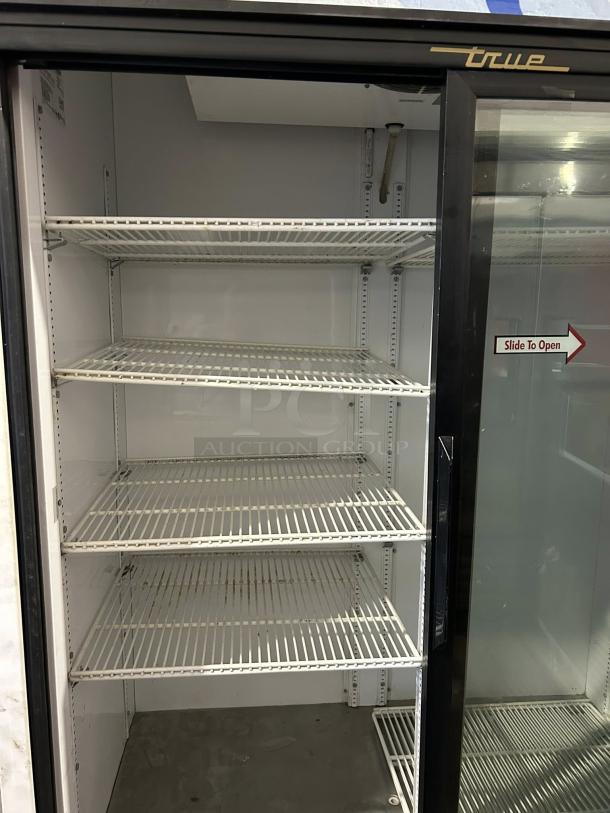 True GDM-45-HC-LD glass door merchandiser with sliding doors, black, tested working, shelves present, 51 1/8", 115v.