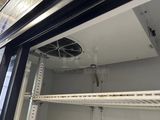 True GDM-45-HC-LD glass door merchandiser interior, visible shelves and cooling fan, black finish, tested and working condition.