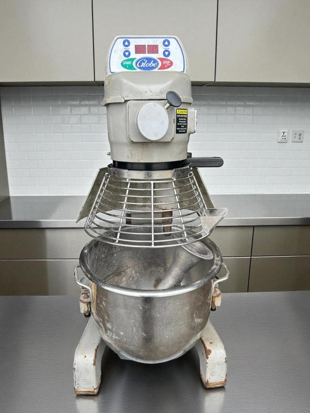 Globe SP20 20 qt planetary mixer in great condition. Bench model, 1/2 hp, 115v. Tested and working. Visible wear on base.