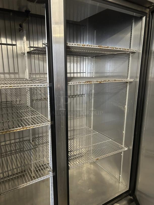 True T-49F-HC reach-in freezer with two solid hinged doors, excellent condition, tested and working, visible shelving inside.