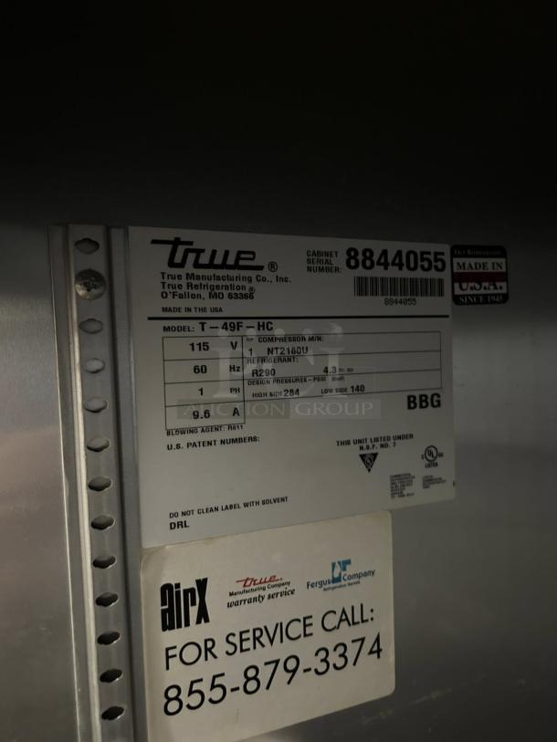 Tag on True T-49F-HC freezer detailing model, serial number 8844055, and specs like voltage, refrigerant, and patent info.