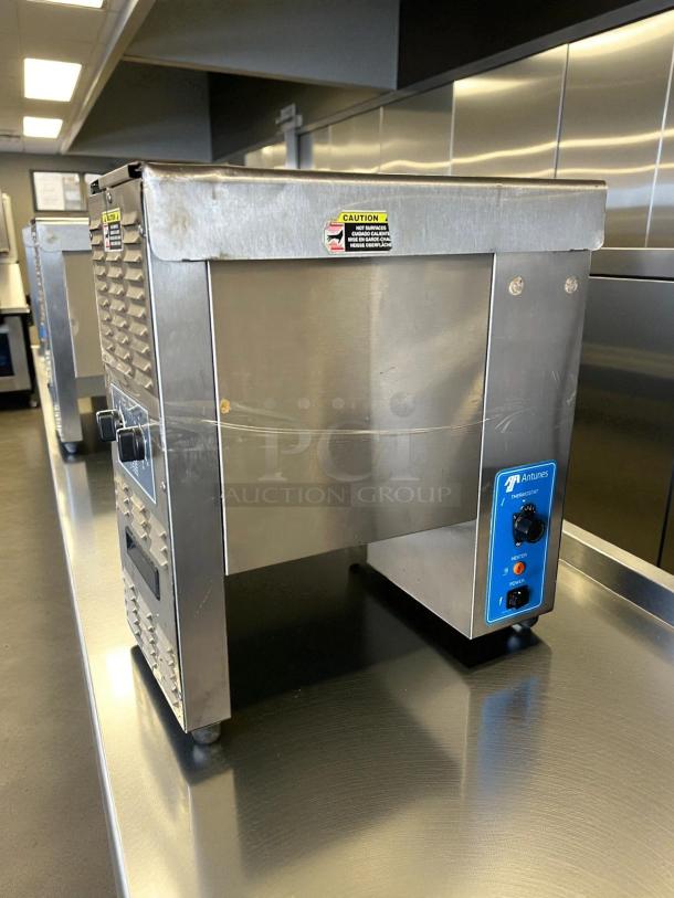 Antunes VCT-1000 Bun Toaster in excellent condition, stainless steel, 424 slices/hr, tested and working, caution labels visible.