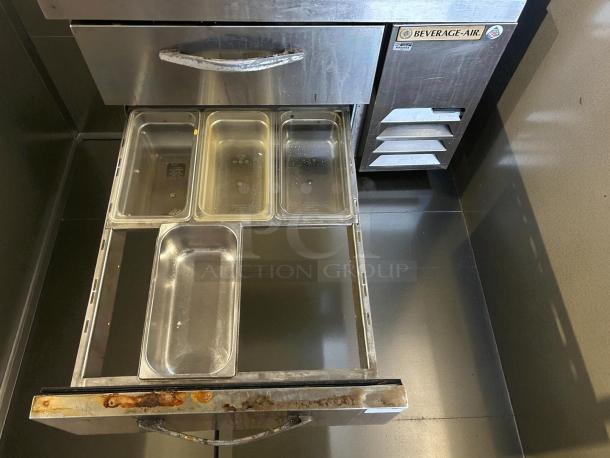 Beverage Air WTRCS36HC chef base with two refrigerated drawers, visible wear, includes four stainless steel pans, and branding tag.