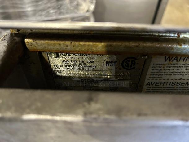 Jade Range JTRH griddle label, showing ANSI, NSF, and CSA certifications. Metal surface around label, in well-used condition.