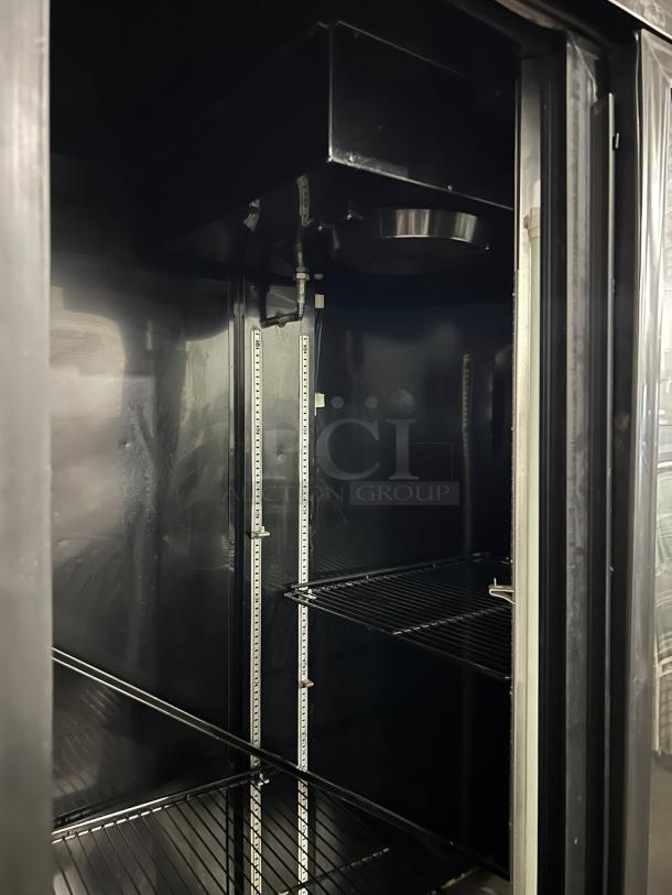 Bush Refrigeration FS52GDHC sliding door refrigerator, tested and working, featuring adjustable shelving in good condition.