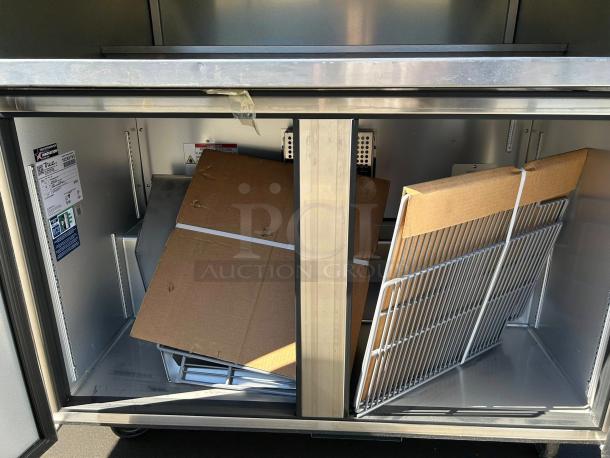 Like new True TUC-48-HC undercounter refrigerator with two sections and doors, energy-efficient. Tags show model details.