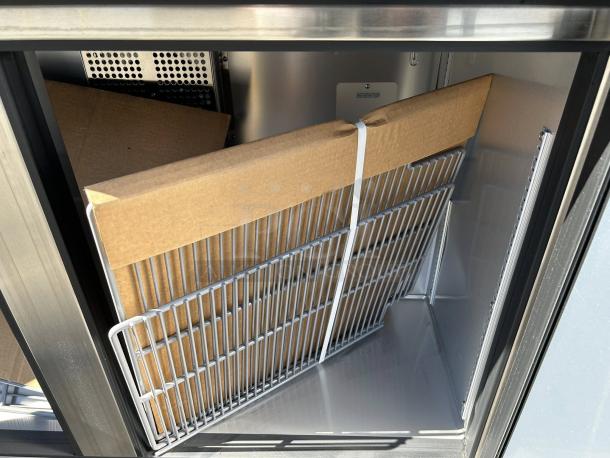 True TUC-48-HC 48" undercounter refrigerator, like new condition, with two sections and doors, inside view with shelving.