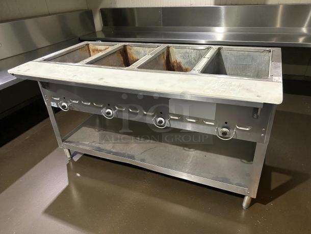 Duke 304 4-Well Aerohot Steamtable, 55-3/8", natural gas, great condition, tested and working, metal frame, burner controls visible.