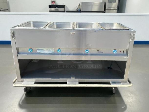 Duke E304 58 3/8" hot food table with 4 wells, cutting board, 240v/1ph. Tested and working condition.