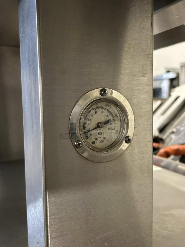 Royston heated display case with 74" size, 2 open tiers, 220v-240v, 3-phase. Tested, working, with temperature gauge showing NSF mark.