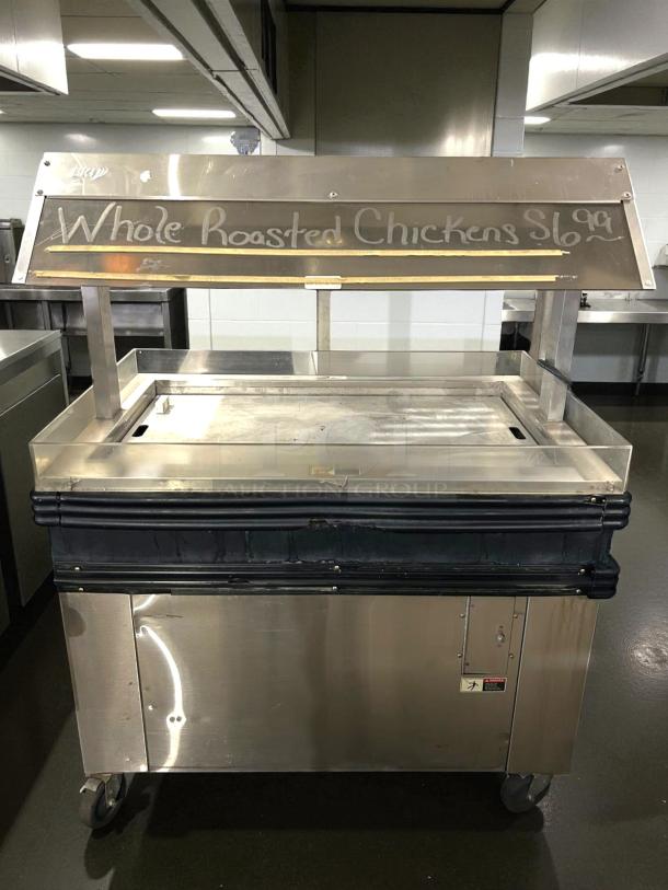 BKI MM-4 4ft mobile hot deli display for rotisserie chicken, excellent condition, tested, 120V, visible price sign.