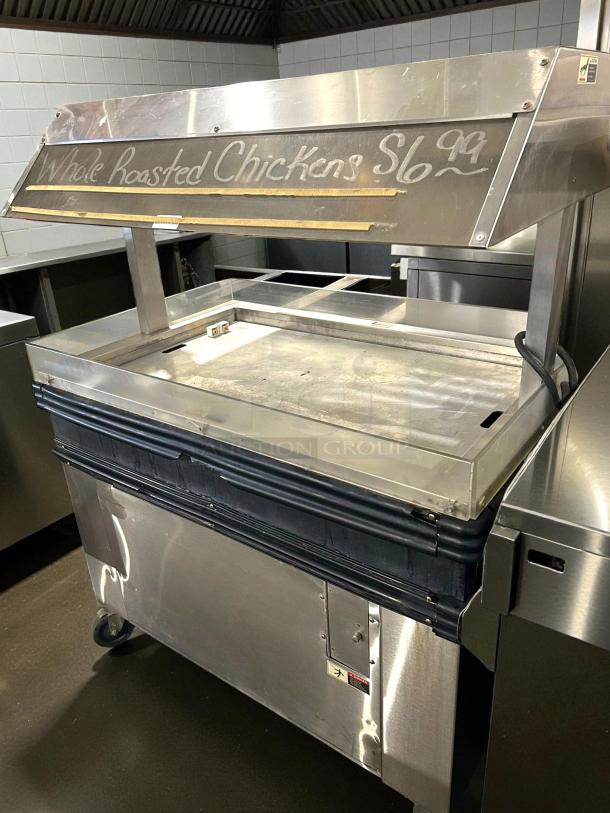 BKI MM-4 4ft mobile heated display for rotisserie chicken, excellent condition, 120V, tested and working, with price signage.