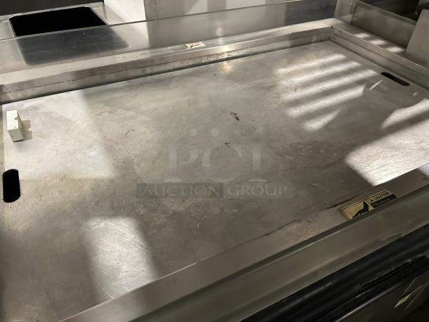 BKI MM-4 4ft mobile hot deli heated display for rotisserie chicken, shown in excellent condition, tested and working. "Caution" label visible.