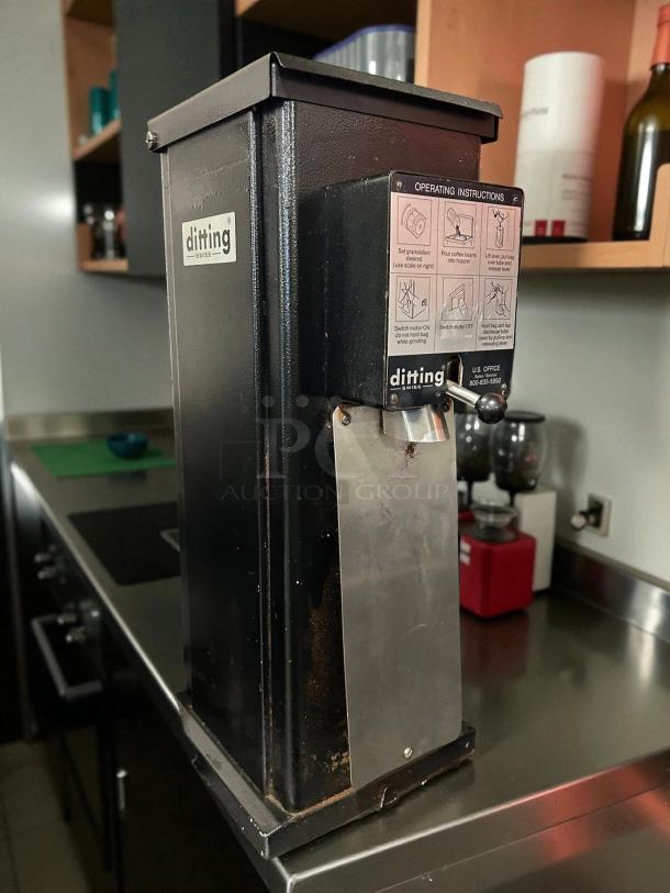 Ditting KR1403 commercial coffee grinder in great condition, black finish, tested and working, with operational instructions visible.