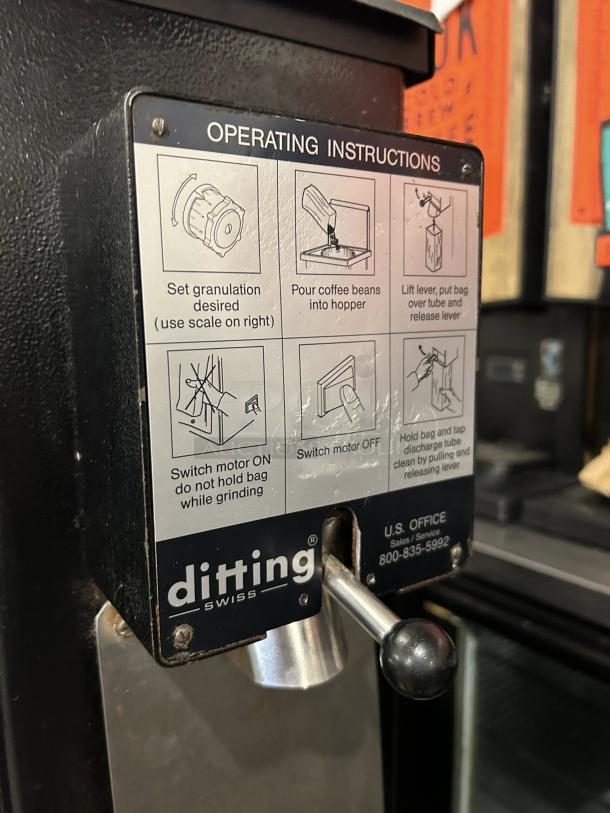 Ditting KR1403 commercial coffee grinder in great condition with visible operating instructions and contact details.