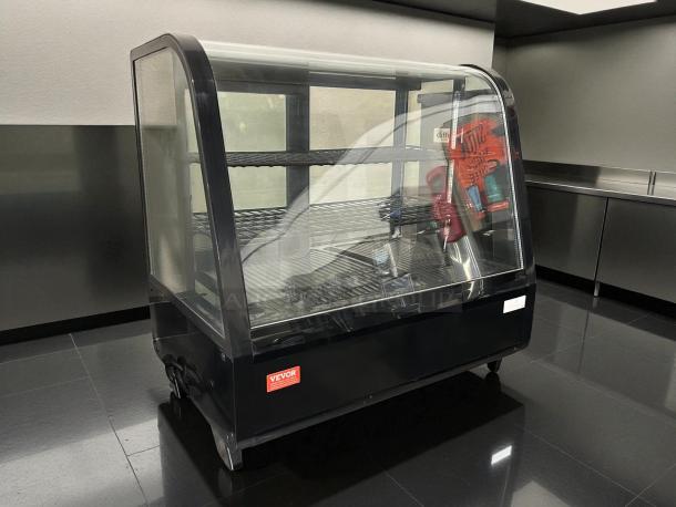 VEVOR Refrigerated Display Case, model XCW-100L, 4.2 Cu.Ft., 2-tier, excellent condition, black frame, visible VEVOR label.