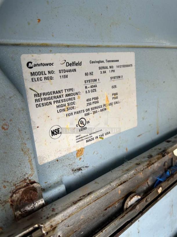 Label on Delfield STD4464N-12 sandwich prep table showing model, serial number, refrigerant details, and NSF certification.