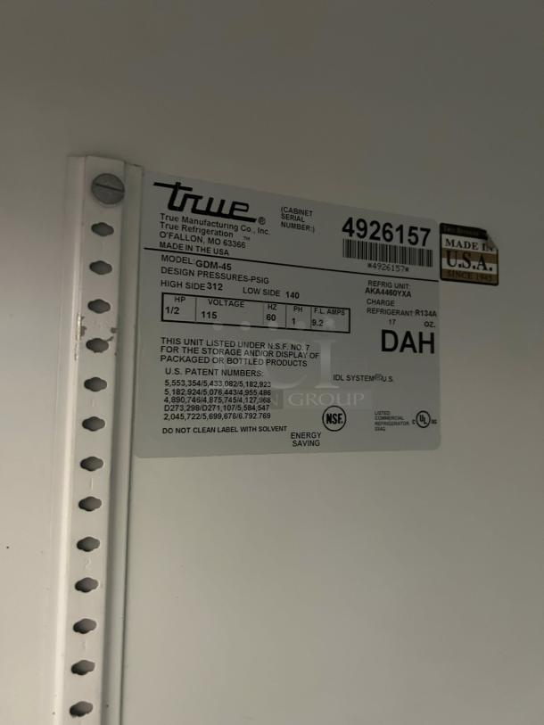 Tag showing model True GDM-45-HC-LD, 115v, NSF listed, made in USA by True Manufacturing Co., 51 1/8" merchandiser.