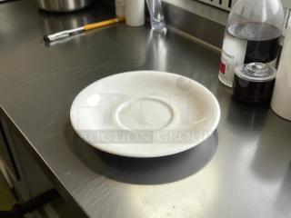 Tuxton No. 07 6” white dinner plate, like new condition, on a stainless steel surface.