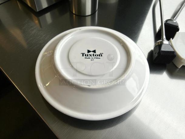 Tuxton No. 07 6” white dinner plate, like new, shows manufacturer mark "Tuxton Made in China 07."