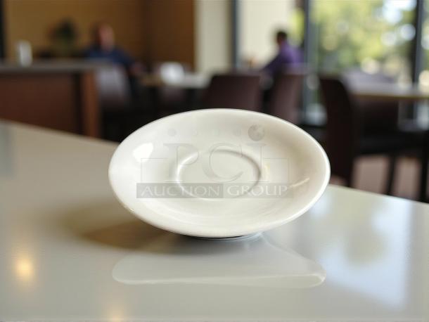 Tuxton No. 07 6” white dinner plate, in like-new condition, displayed on a table.