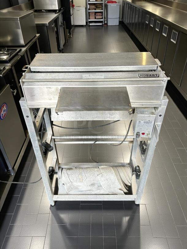 Hobart W32-6 hand wrap station, 3 roll film capacity, 120v, gently used, tested working, visible Hobart logo.