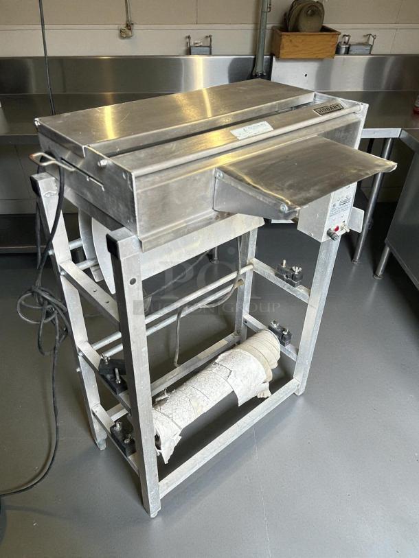Hobart W32-6 Hand Wrap Station, 3 roll film capacity, 120v, metal construction, used, tested and working.