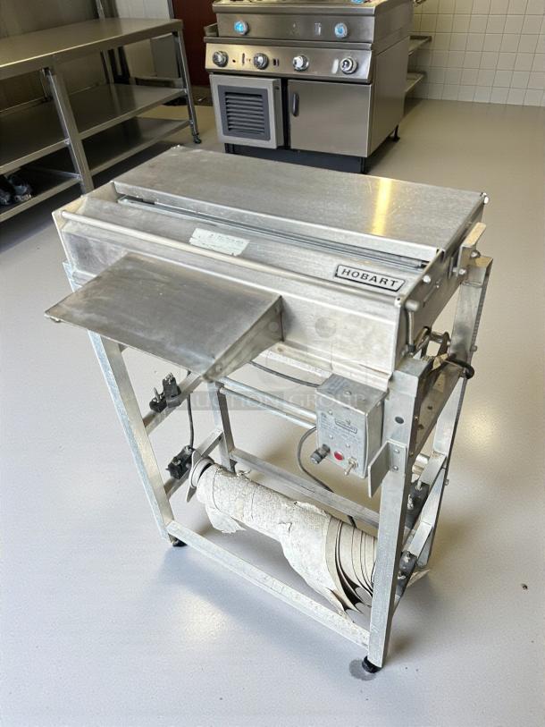 Hobart W32-6 hand wrap station, 3 roll capacity, stainless steel, tested working condition, visible brand label.