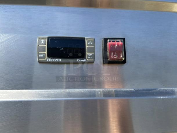 Control panel of Kintera KBM3F bottom mount freezer. Display shows temperature settings with Dixell branding, metal finish.