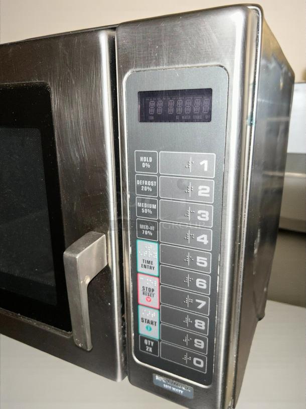 Amana RFS12TS 1200w commercial microwave with a touch pad, 120v. Tested, working, used condition. Keypad shows various controls.