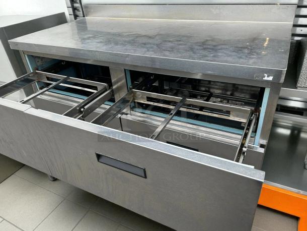 Delfield STD4464N 4-Drawer Refrigerated Chef Base in pristine condition, showing open drawers and stainless steel surface.