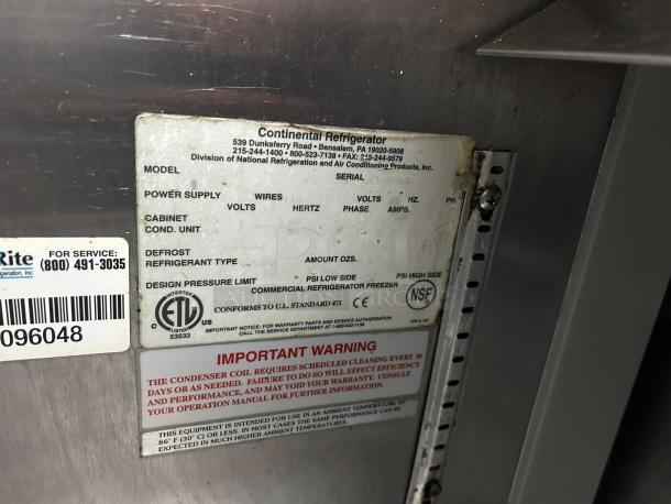 Alt text: Close-up of a Continental Refrigerator label on a sandwich prep table, showing model and service information.